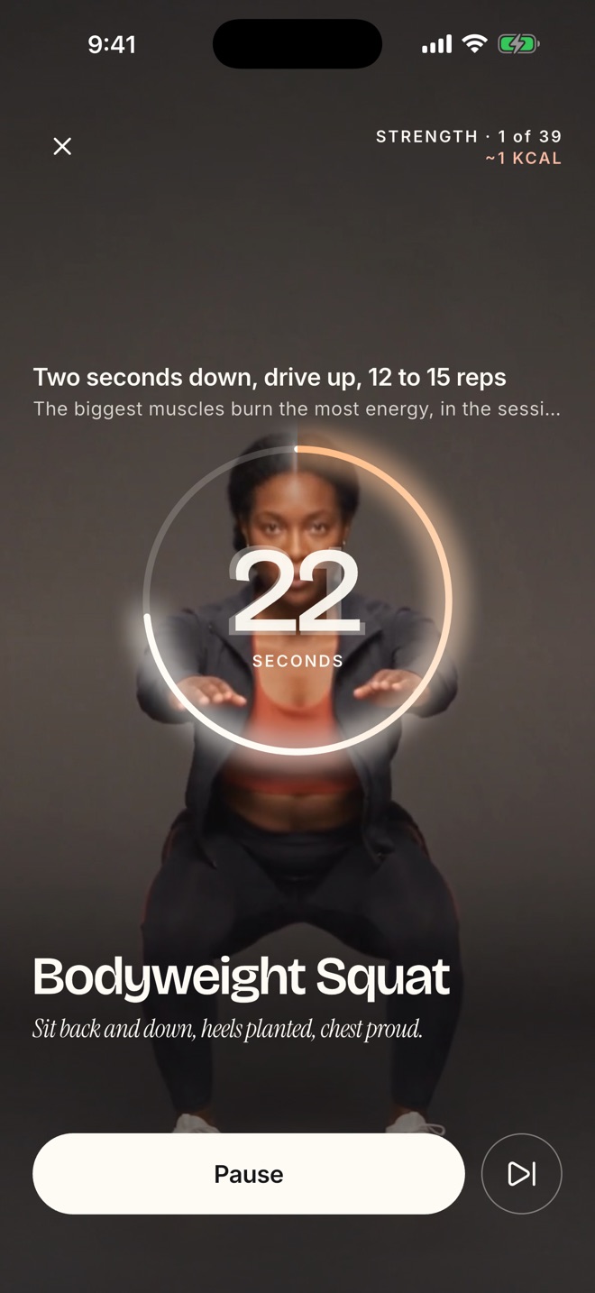 The Melt session player: Maya in a bodyweight squat behind a 22 second timer ring, the block label Strength 1 of 39, and the cue two seconds down, drive up, 12 to 15 reps